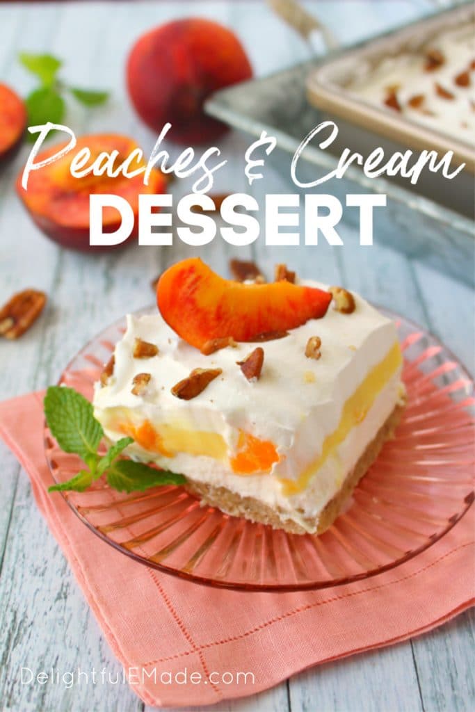 Peach delight dessert square on a plate, topped with chopped pecans and a fresh peach slice. Sprig of fresh mint leaves on the side.