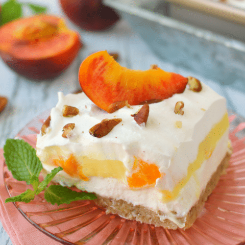 If you love fresh, summer peaches this dessert is for you! My Peaches & Cream Dessert Bars have a Pecan Sandie cookie crust, cream cheese filling, fresh peaches and toasted pecans! You don't have to be a Southerner to enjoy this fabulous dessert!