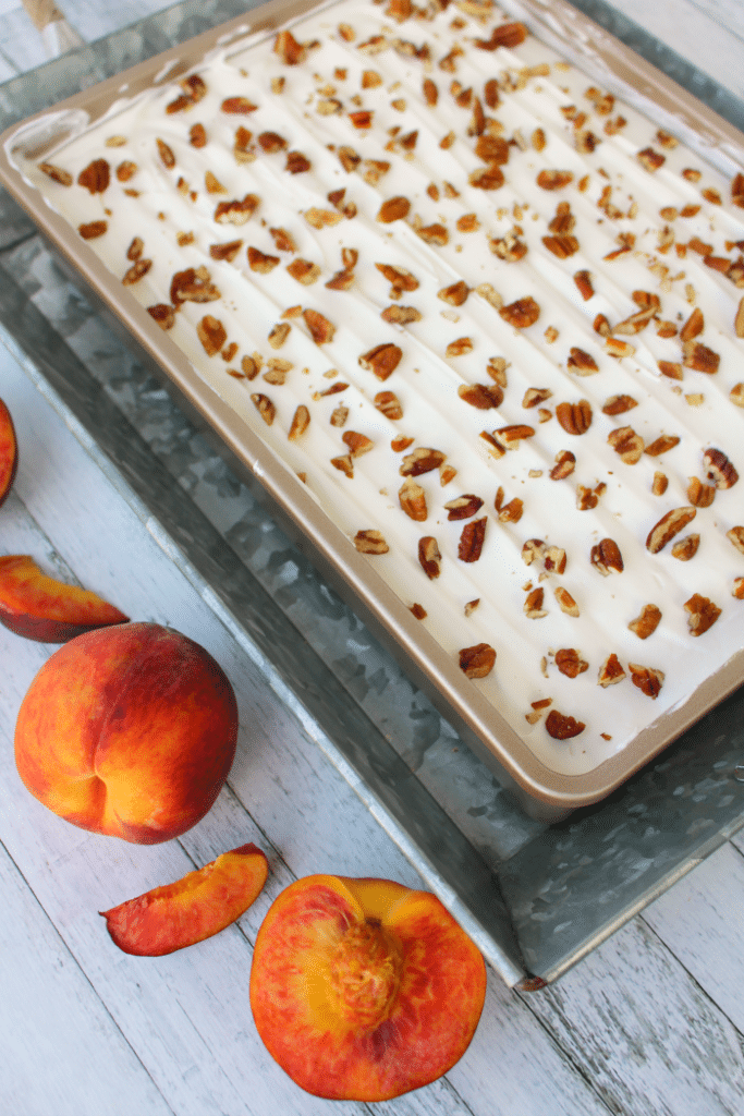 If you love fresh, summer peaches this dessert is for you! My Peaches & Cream Dessert Bars have a Pecan Sandie cookie crust, cream cheese filling, fresh peaches and toasted pecans! You don't have to be a Southerner to enjoy this fabulous dessert!