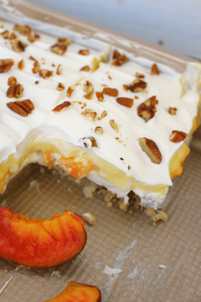 If you love fresh, summer peaches this dessert is for you! My Peaches & Cream Dessert Bars have a Pecan Sandie cookie crust, cream cheese filling, fresh peaches and toasted pecans! You don't have to be a Southerner to enjoy this fabulous dessert!