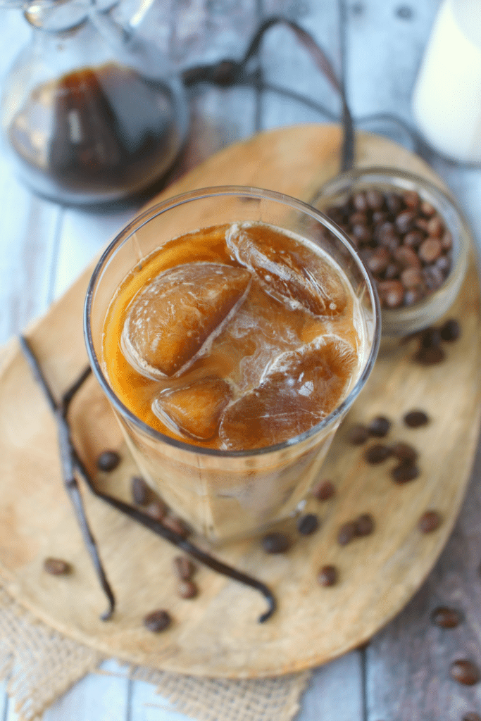 Forget the morning rush at your local coffee shop - make your favorite vanilla iced coffee drink right at home!  My Vanilla Bean Iced Coffee is made with a super-simple vanilla bean syrup, as well as cold brew coffee, and half and half.  An amazing drink to start your day!