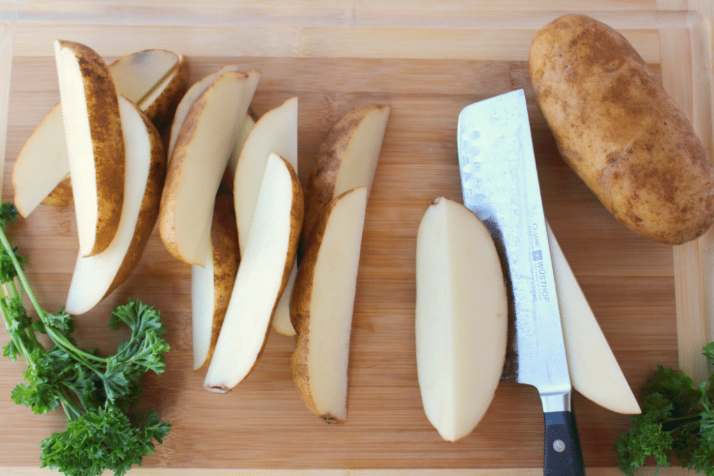 These crispy, oven-baked fries will be a new favorite side with everyone in your family! Russet potato wedges are coated in Parmesan cheese, ranch seasoning, and a bit of parsley, they come together in moments, and bake to perfection! Fantastic with anything from sloppy joes to steak and everything in between!