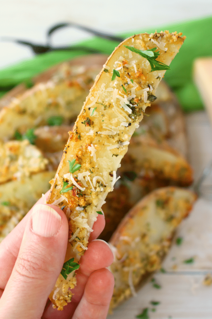 These crispy, oven-baked fries will be a new favorite side with everyone in your family! Russet potato wedges are coated in Parmesan cheese, ranch seasoning, and a bit of parsley, they come together in moments, and bake to perfection! Fantastic with anything from sloppy joes to steak and everything in between!