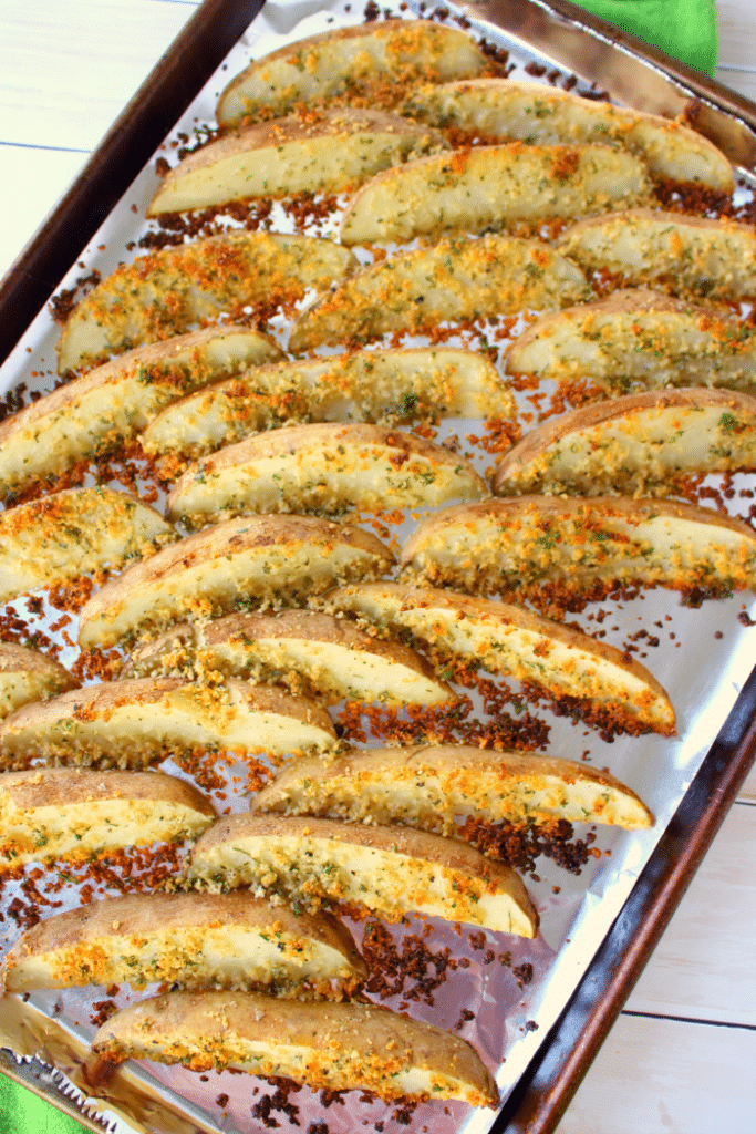 These crispy, oven-baked fries will be a new favorite side with everyone in your family! Russet potato wedges are coated in Parmesan cheese, ranch seasoning, and a bit of parsley, they come together in moments, and bake to perfection! Fantastic with anything from sloppy joes to steak and everything in between!