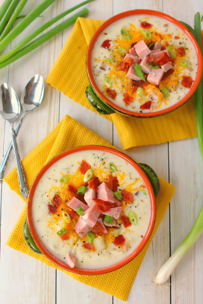 The best potato soup you'll ever have! Made in the slow cooker, this super-simple soup recipe is great for busy weeknights. Loaded with big chunks of ham, potatoes, and topped with lots of cheese, bacon and onions, this comfort food is a great for anyone who loves a hearty, delicious bowl of soup!
