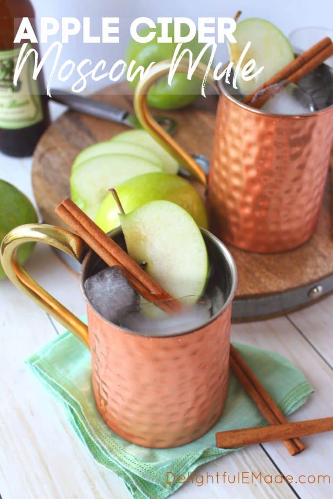 Apple Cider Moscow Mules garnished with apple slices and cinnamon sticks.