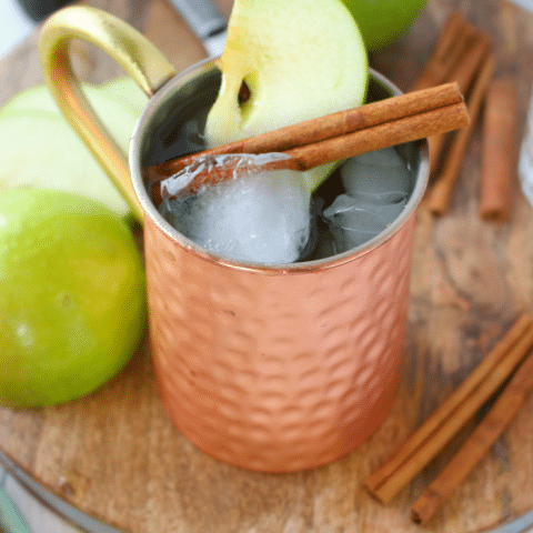 The perfect apple cocktail to enjoy on a crisp autumn day! My Apple Ginger Moscow Mule is made with spiced apple cider, Ginger liqueur, Ginger beer, and topped with a fresh, crisp Granny Smith Apple slice! How 'bout them apples?!