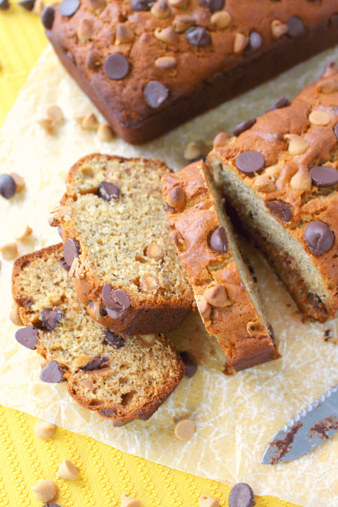 Your new favorite banana bread recipe is here! This flavorful, delicious banana bread is loaded with chocolate chips, creamy peanut butter, and peanut butter chips, making an amazing breakfast treat or afternoon snack. Starbucks banana loaf has got nothin' on this!