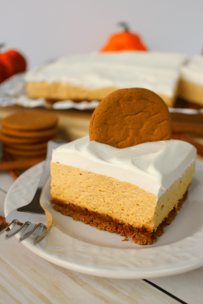 Let me introduce you to your new favorite fall dessert! Made with a Gingersnap Cookie Crust, whipped topping and a few other goodies, these No Bake Pumpkin Cheesecake Bars are simple enough for a casual fall celebration and decadent enough for Thanksgiving dinner!