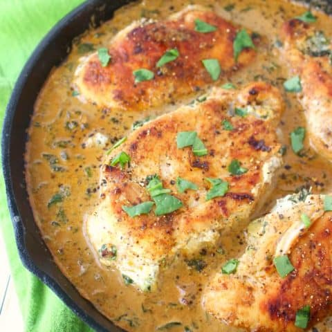 Let me introduce you to your new favorite chicken recipe! This easy one skillet meal has all the flavors of Spinach and Artichoke Dip simmered together and stuffed into simple chicken breasts. Incredibly flavorful, this delicious entree is the perfect dinner idea any night of the week!