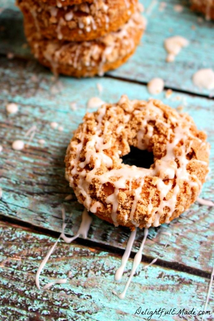 Need an excuse to do some fall baking? My Pumpkin Coffee Cake Donuts are the perfect recipe to indulge your pumpkin spice cravings! Baked, not fried, these pumpkin cake donuts are topped with a cinnamon streusel and lightly glazed for the ultimate breakfast treat!
