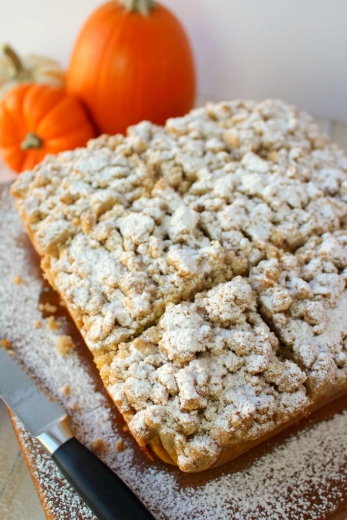 Meet your new favorite crumb cake recipe!  This incredibly moist, velvety pumpkin crumb cake has all your favorite fall flavors topped with an amazing cinnamon crumble.  It's the perfect pumpkin coffee cake to serve on Thanksgiving morning, or simply enjoy with your pumpkin spice latte!