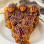 Your favorite pie recipe made even more decadent and delicious! Dark chocolate is added to this pecan pie recipe and topped with chocolate covered pecans for a show-stopping dessert! This pie is perfect for your Thanksgiving or Christmas dessert table!