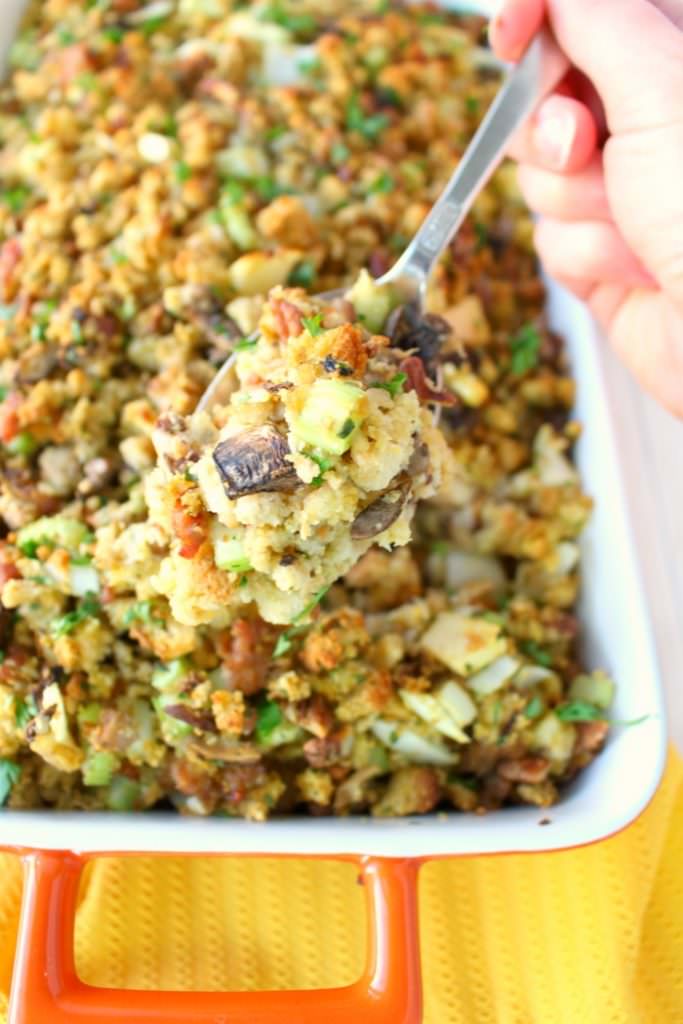 This Thanksgiving stuffing recipe will be an instant holiday dinner favorite with everyone at the table!  Loaded with apples, sausage, mushrooms, pecans and more, this dressing is the ultimate side dish for your holiday meal! Can be made in the oven or slow cooker!
