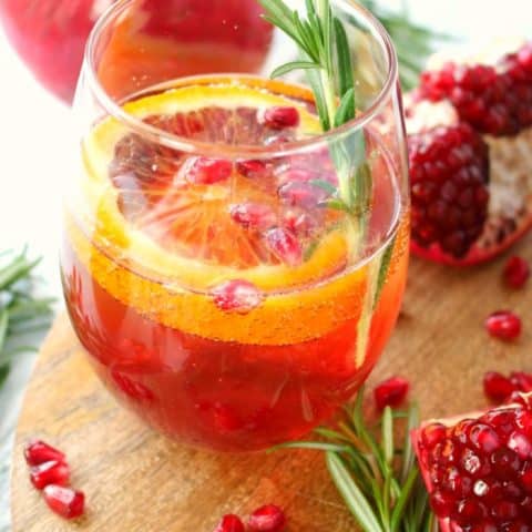 Want a delicious, classy cocktail that everyone at your holiday party will love? My Pomegranate Citrus Champagne Cocktail is made with sweet blood orange slices, pomegranate juice and seeds, citrus vodka and topped with Champagne. This libation is perfect for Thanksgiving, Christmas, New Years and fantastic for brunch, too!
