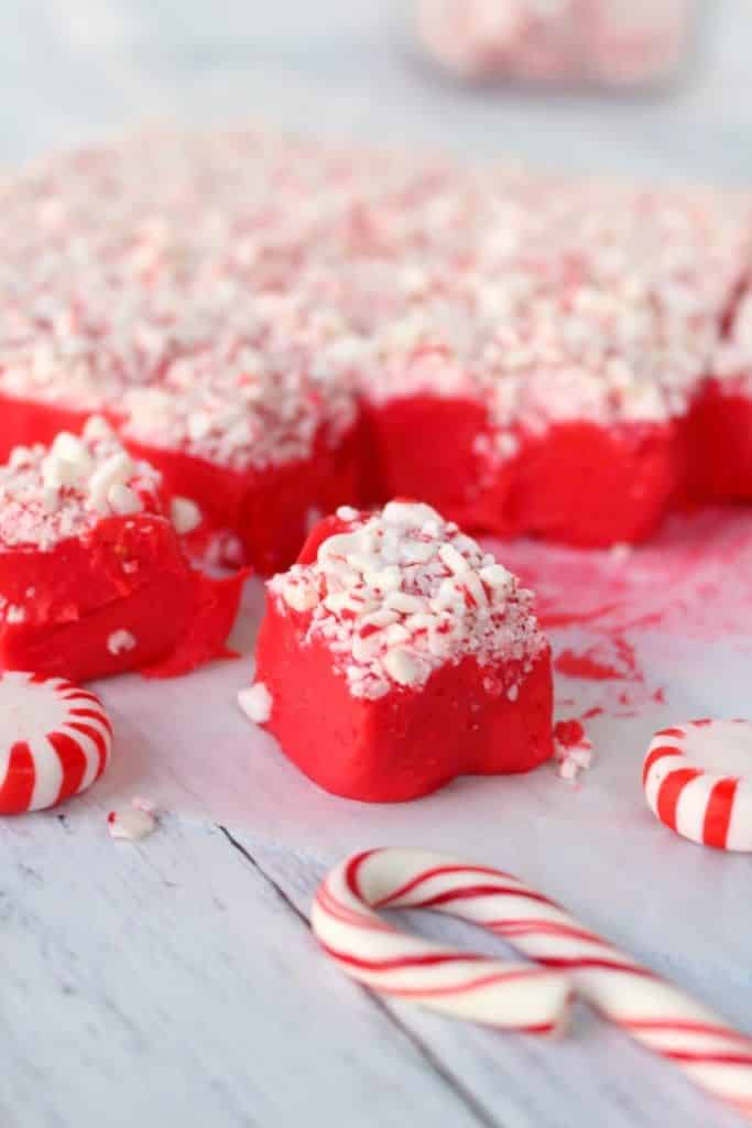 This gorgeous Peppermint Red Velvet Fudge is the perfect way to ring in the holiday season! This easy microwave fudge recipe is perfect for your holiday candy trays, cookie exchanges and Christmas parties!