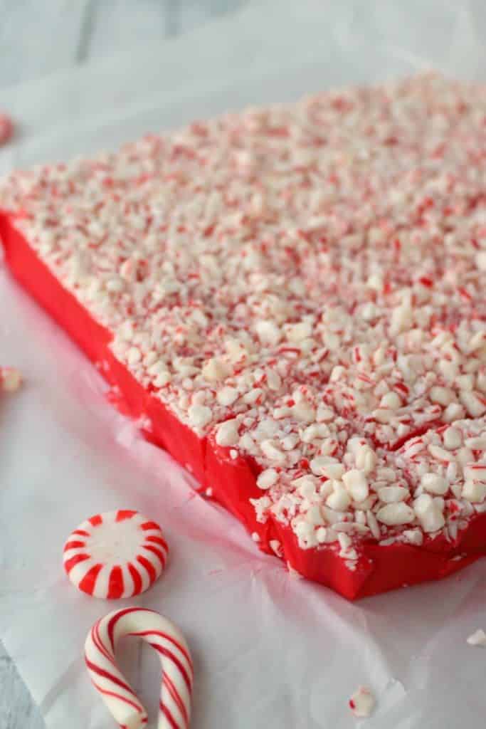 This gorgeous Peppermint Red Velvet Fudge is the perfect way to ring in the holiday season! This easy microwave fudge recipe is perfect for your holiday candy trays, cookie exchanges and Christmas parties!