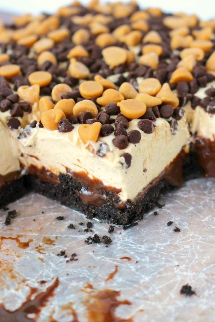 Slices of no bake chocolate peanut butter cheesecake bars.