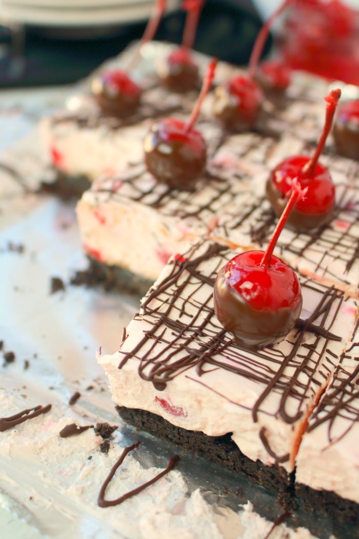 No bake cheesecake bars don't get better than this! Made with an OREO crust, a creamy no bake cherry cheesecake filling, and topped with a chocolate drizzle and chocolate dipped cherries, these bars are incredible. Easy to make, and completely delicious!