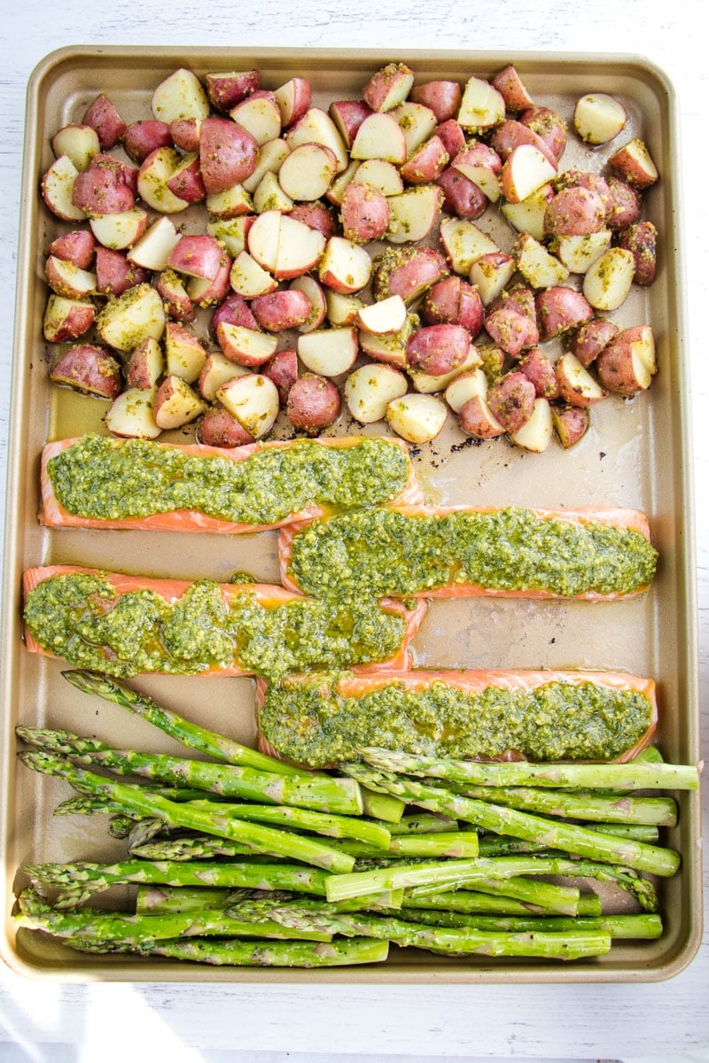 Sheet Pan salmon and asparagus with pesto and potatoes.
