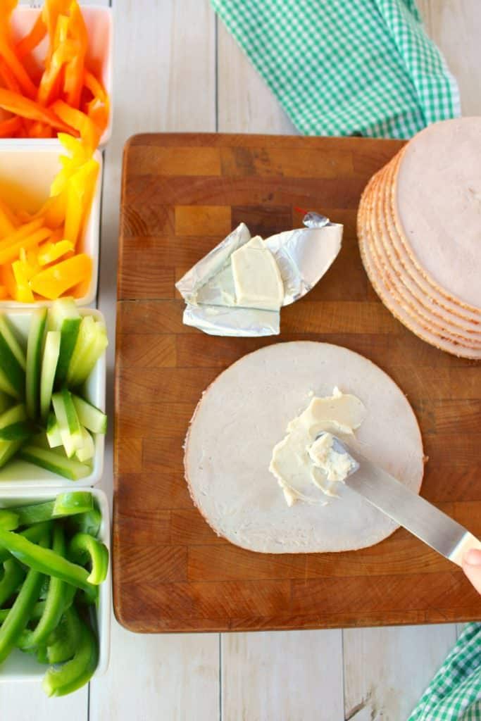 These super simple turkey wraps are the ultimate snack or light lunch when you're looking to make healthier choices! Uses simple deli turkey, fresh sliced peppers and cucumbers and a wedge of Laughing Cow Cheese. Just 3 Weight Watchers Smart Points!!