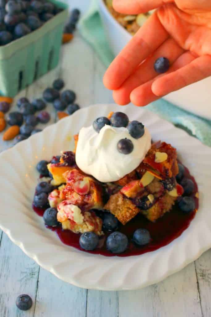 The ultimate baked French toast recipe! Blueberries and cream cheese are stars of this easy French toast casserole, which is topped with a cinnamon almond streusel and baked to perfection. Serve with blueberry syrup and whipped cream for the most amazing breakfast ever!