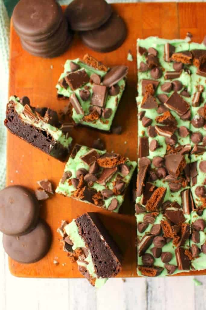 Let me introduce you to your new favorite brownie recipe! A perfect combination of chocolate and mint, these fudgy mint brownies are topped with Girl Scout Thin Mint Cookies, Andes mints, chocolate chips, and an amazing layer of mint butter cream frosting. Most definitely a brownie lover's dream come true!