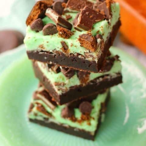 Let me introduce you to your new favorite brownie recipe! A perfect combination of chocolate and mint, these fudgy mint brownies are topped with Girl Scout Thin Mint Cookies, Andes mints, chocolate chips, and an amazing layer of mint butter cream frosting. Most definitely a brownie lover's dream come true!