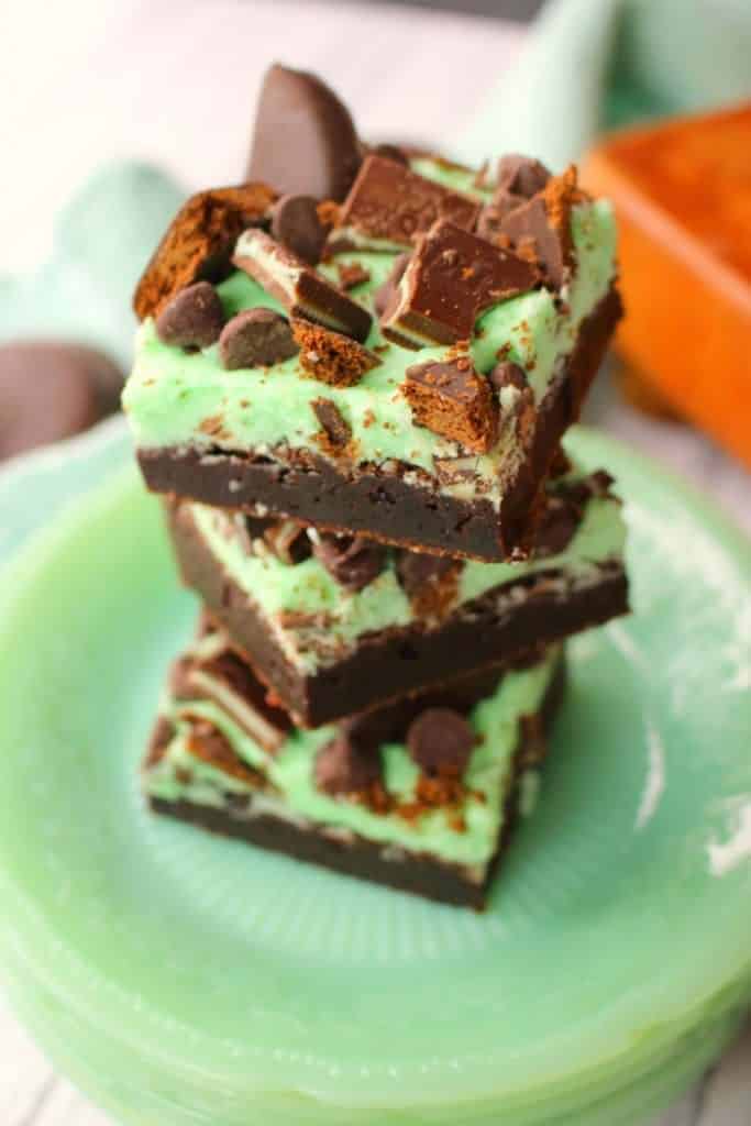 Let me introduce you to your new favorite brownie recipe! A perfect combination of chocolate and mint, these fudgy mint brownies are topped with Girl Scout Thin Mint Cookies, Andes mints, chocolate chips, and an amazing layer of mint butter cream frosting. Most definitely a brownie lover's dream come true!