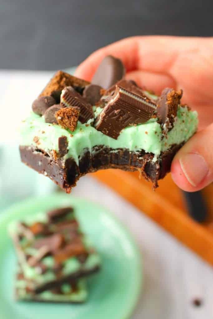 Let me introduce you to your new favorite brownie recipe! A perfect combination of chocolate and mint, these fudgy mint brownies are topped with Girl Scout Thin Mint Cookies, Andes mints, chocolate chips, and an amazing layer of mint butter cream frosting. Most definitely a brownie lover's dream come true!