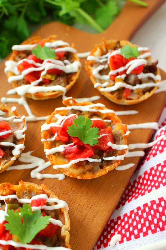 These Easy Baked Mini Tacos will be your new favorite appetizer! Loaded with all your Tex-Mex favorites and topped with Ro*Tel, these mini tacos will be perfect for enjoying with friends at your next watch party!