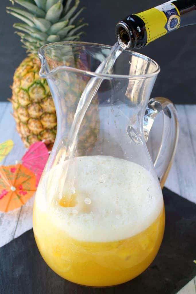 This Pina Colada recipe will be your new favorite happy hour drink! Made with four simple ingredients, this fantastic champagne punch is perfect for parties, showers, and girls nights! Forget the blender, this amazing pineapple coconut cocktail is super easy and completely delicious!