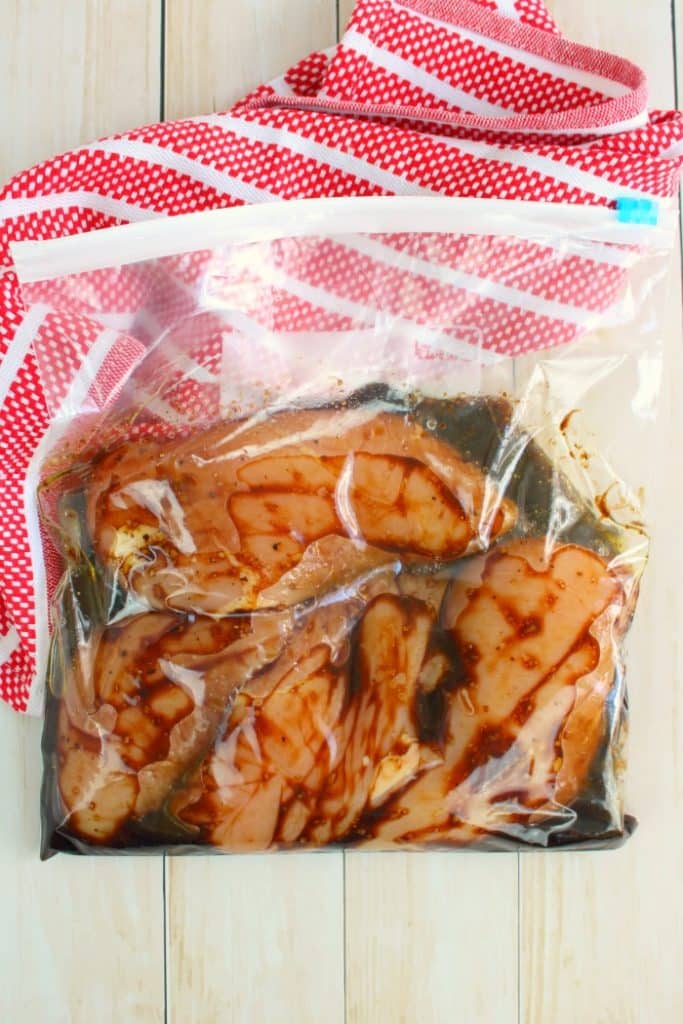 Chicken breasts in a ziploc bag marinating in balsamic marinade.