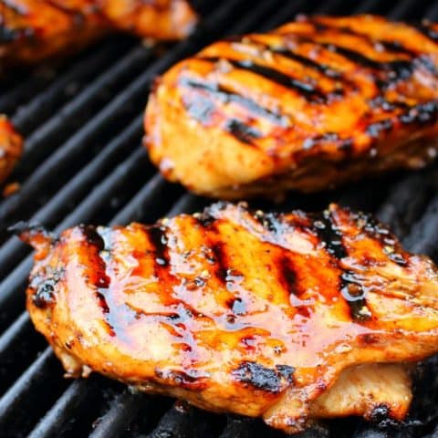Balsamic marinated chicken on grill glazed with balsamic marinade.