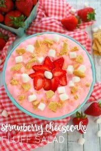 This creamy, delicious strawberry marshmallow fluff is the ultimate summer salad! Made with fresh strawberries, marshmallows, cream cheese, jell-o and whipped topping, this easy strawberry fluff salad recipe will be your new go-to cookout dish!