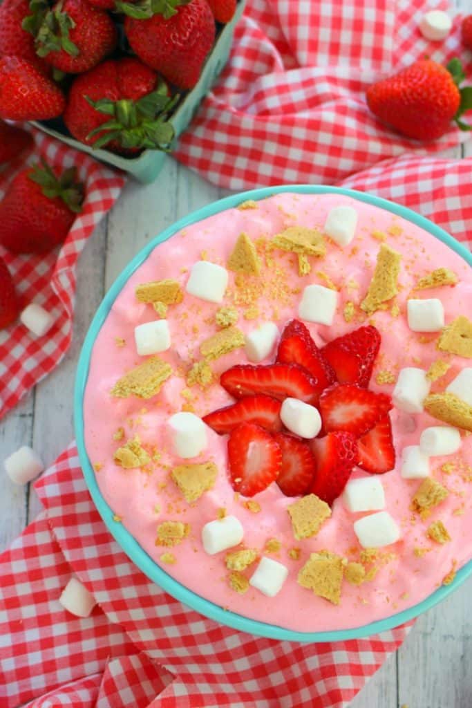 This creamy, delicious strawberry marshmallow fluff is the ultimate summer salad! Made with fresh strawberries, marshmallows, cream cheese, jell-o and whipped topping, this easy strawberry fluff salad recipe will be your new go-to cookout dish!