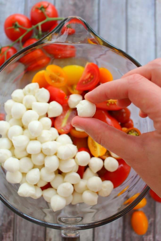 With just 6 ingredients, this simple tomato salad recipe will be your new go-to summer side!  Made with fresh cherry tomatoes, mozzarella, basil and a 3 ingredient balsamic vinaigrette, this caprese salad takes just minutes to make and tastes incredible!