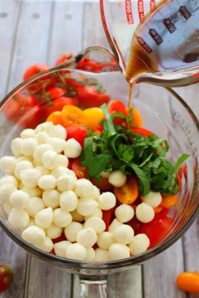 With just 6 ingredients, this simple tomato salad recipe will be your new go-to summer side!  Made with fresh cherry tomatoes, mozzarella, basil and a 3 ingredient balsamic vinaigrette, this caprese salad takes just minutes to make and tastes incredible!