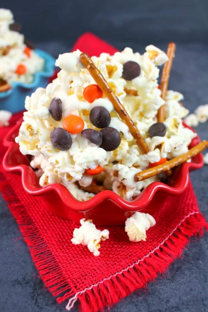 Want a fun popcorn snack mix to go with your hot cocoa? This Melted Snowman Popcorn Snack Mix is fantastic for a snow day! Made with just 5 simple ingredients, this snack mix recipe is great for watching Christmas movies or snacking after building a snowman.