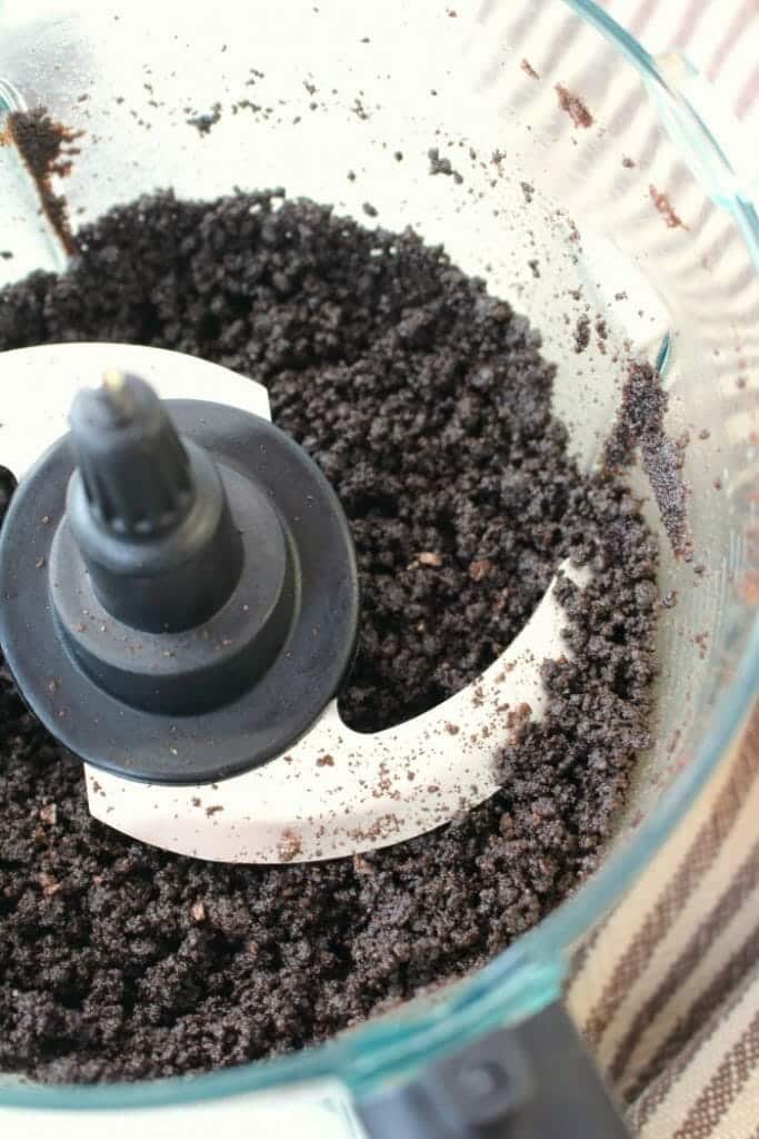 Crushed oreo cookie crumbs in food processor.