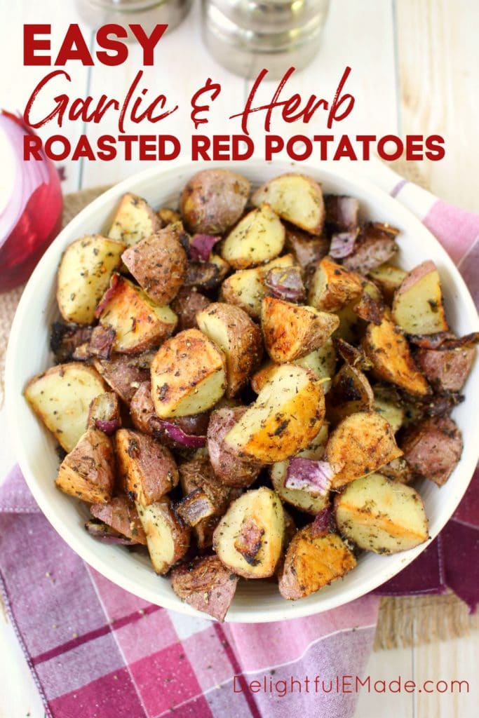 Bowl of garlic herb roasted red potatoes with red onions, sprinkled with salt and pepper.