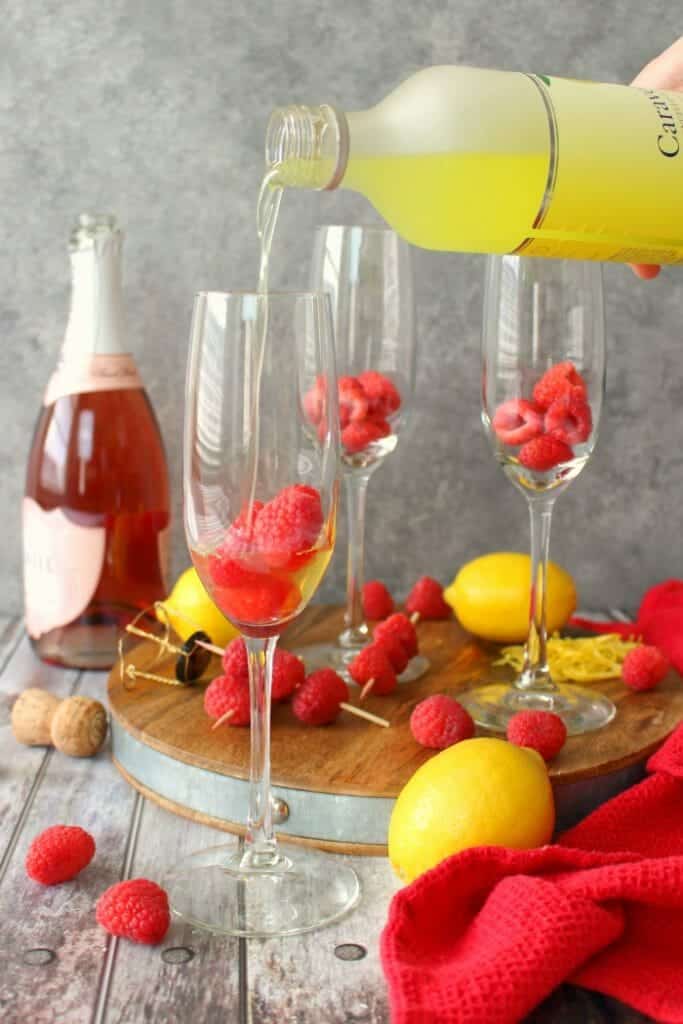 Mimosas brought to a whole new, glorious level! These Lemon Raspberry Mimosas are made with fresh raspberries, lemoncello liqueur, and topped off with a Champagne Rosé. Your brunch just got even more fabulous!