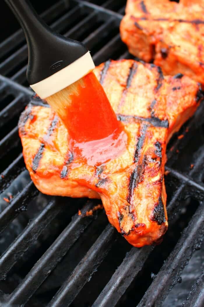 Meet your new favorite BBQ Pork Chops recipe! These super-simple grilled pork chops are made with a homemade honey bourbon barbecue sauce, and grilled to perfection. This will be your new favorite way to grill pork chops!