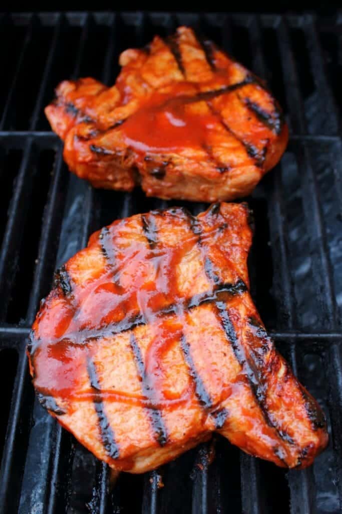 Meet your new favorite BBQ Pork Chops recipe! These super-simple grilled pork chops are made with a homemade honey bourbon barbecue sauce, and grilled to perfection. This will be your new favorite way to grill pork chops!