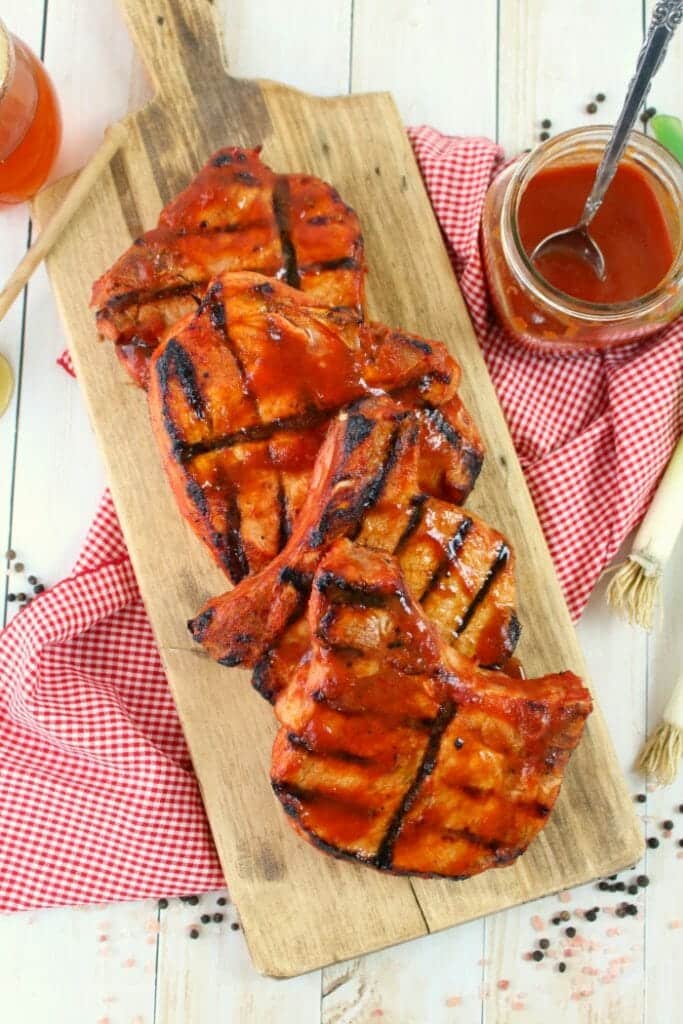 Meet your new favorite BBQ Pork Chops recipe! These super-simple grilled pork chops are made with a homemade honey bourbon barbecue sauce, and grilled to perfection. This will be your new favorite way to grill pork chops!