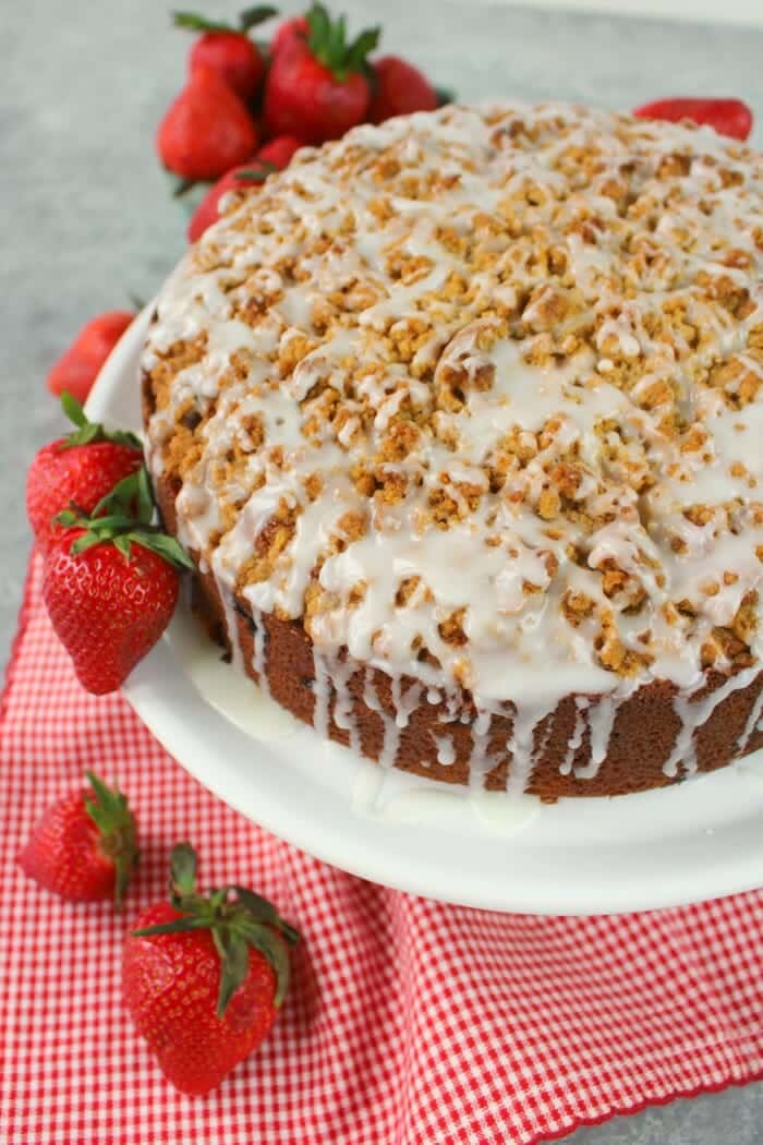 Strawberry coffee cake, garnished with whole strawberries.