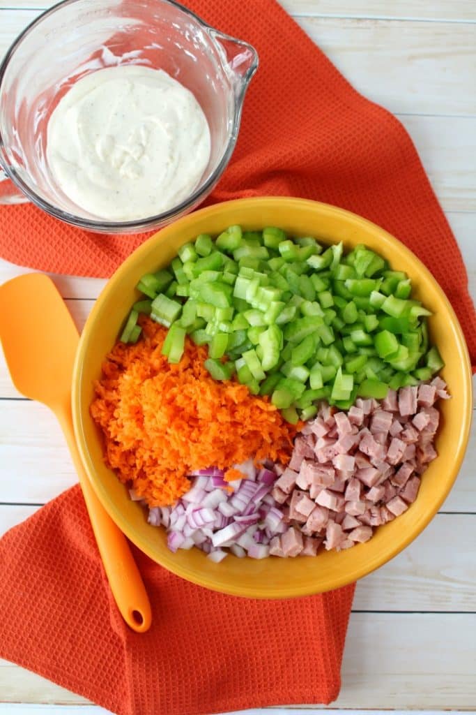 The BEST Macaroni Salad recipe! Loaded with fresh carrots, celery, diced bell pepper, red onion, and savory ham, this Simple & Classic Macaroni Salad is the perfect side dish for your next cookout or pot-luck.
