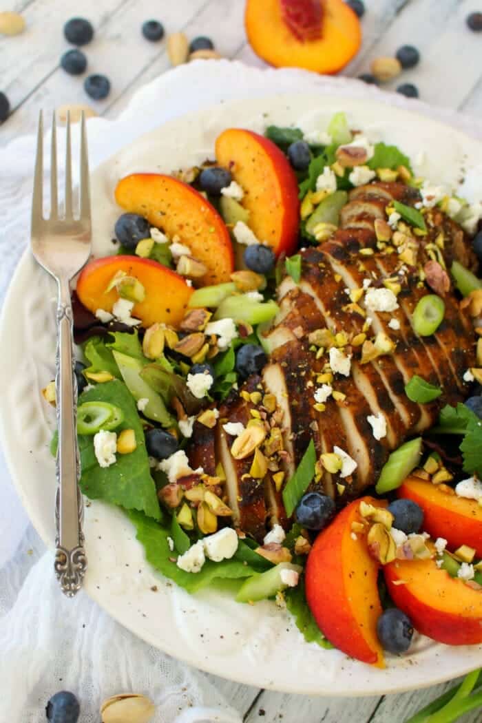 Craving a fresh, crisp entree salad? This savory, and slightly sweet Balsamic Grilled Chicken Salad will totally hit the spot! Made with fresh greens, fruit, pistachios and balsamic grilled chicken, this salad is healthy, filling and completely delicious!