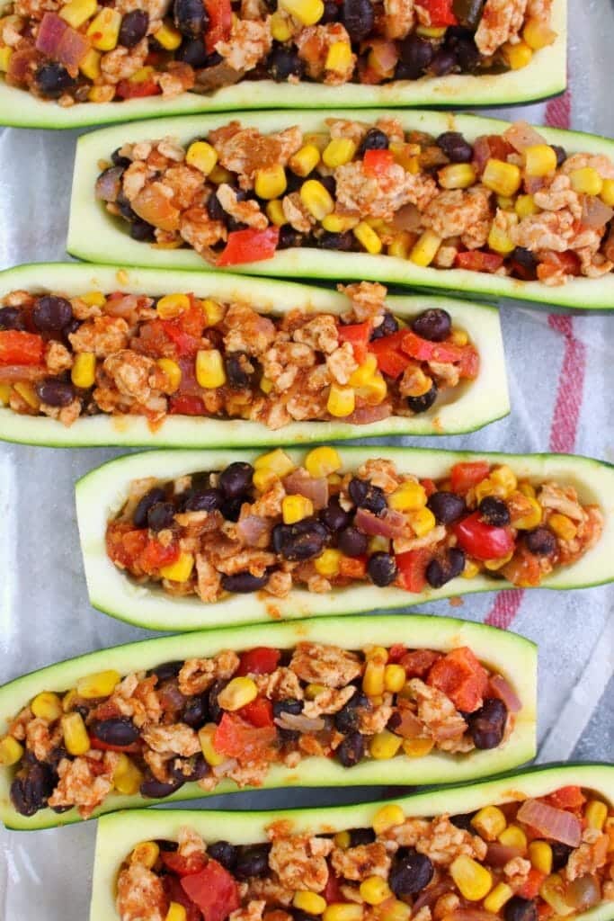 Looking for a healthy, low-carb dinner idea that actually tastes good? These Taco Stuffed Zucchini Boats are made with lean ground turkey filling along with peppers, onions, beans and corn. Loaded with flavor, these stuffed zucchini are the perfect healthy dinner!