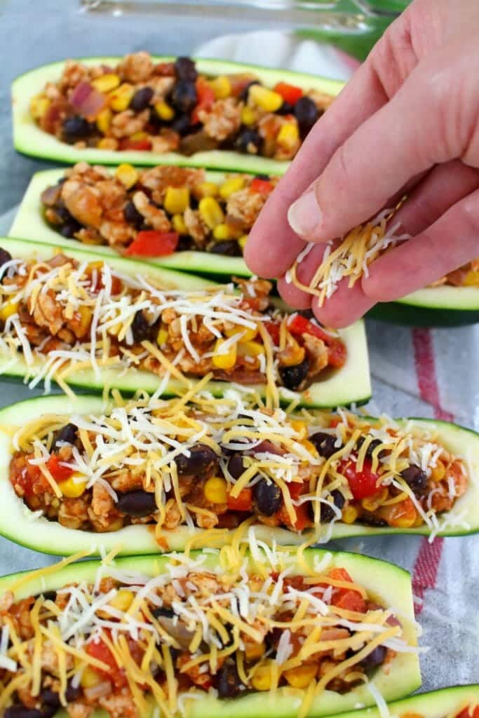 Looking for a healthy, low-carb dinner idea that actually tastes good? These Taco Stuffed Zucchini Boats are made with lean ground turkey filling along with peppers, onions, beans and corn. Loaded with flavor, these stuffed zucchini are the perfect healthy dinner!